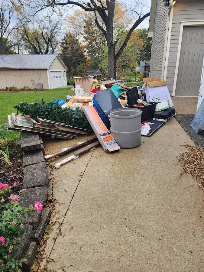 Dumpster being loaded with debris for Estate Cleanout Dumpster Rental in Royalton
